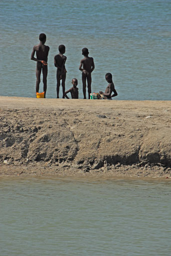 Willow's haiti blog boys on bank midwater lores Boys standing on flooded salt ponds